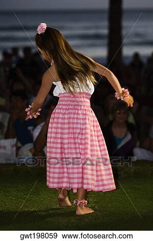 Rear view of a teenage girl hula dancing in a lawn View Large Photo Image Stock Photo - Rear view of a teenage girl hula dancing in a lawn. Fotosearch