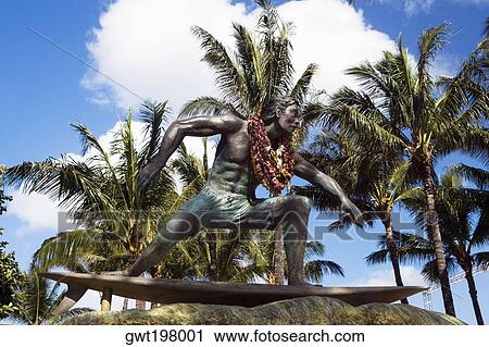 Stock Image - Statue of a man on a surfboard, Waikiki Beach, Honolulu, Oahu, Hawaii Islands, USA. Fotosearch