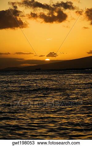 Stock Image - Sunset over the sea, Waikiki Beach, Honolulu, Oahu, Hawaii Islands, USA. Fotosearch