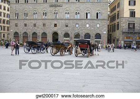 Stock Photo - Horsedrawns in front of a building, Florence, Italy. Fotosearch