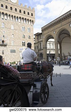 Rear view of a man driving a horsedrawn carriage, Portico of the Lansquenetes, Florence, Italy View Large Photo Image Stock Photography - Rear view of a man driving a horsedrawn carriage, Portico of the Lansquenetes, Florence, Italy. Fotosearch