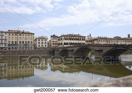 Reflection of an arch bridge in water, Ponte Santa Trinita Bridge, Arno River, Florence, Italy View Large Photo Image Stock Photo - Reflection of an arch bridge in water, Ponte Santa Trinita Bridge, Arno River, Florence, Italy. Fotosearch
