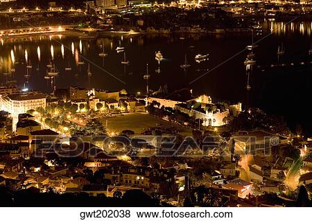 High angle view of buildings lit up at night near a harbor, Nice, France View Large Photo Image Stock Photo - High angle view of buildings lit up at night near a harbor, Nice, France. Fotosearch