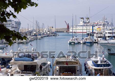 Industrial ship and boats moored at a harbor, Nice, France View Large Photo Image Stock Photo - Industrial ship and boats moored at a harbor, Nice, France. Fotosearch