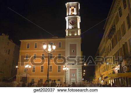 Low angle view of a clock tower lit up at night, Nice, France View Large Photo Image Stock Photo - Low angle view of a clock tower lit up at night, Nice, France. Fotosearch