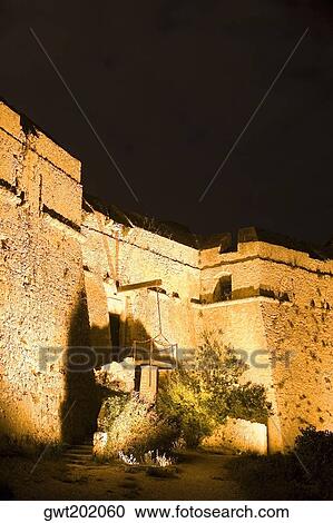 Stock Image - Low angle view of a fort lit up at night, Fort Du Mont Alban, Nice, France. Fotosearch