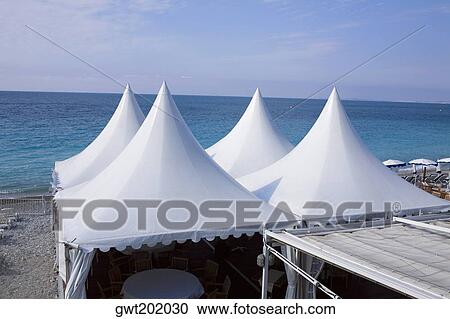 Stock Image - Tents on the beach, Nice, France. Fotosearch