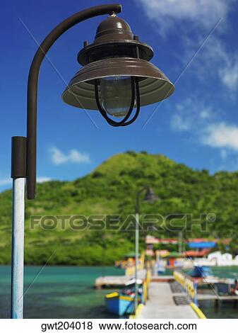 Stock Photo - Close-up of a lamppost with mountains in the background, Lovebird's Bridge, Providencia, Providencia y Santa Catalina, San Andres y Providencia Department, Colombia. Fotosearch