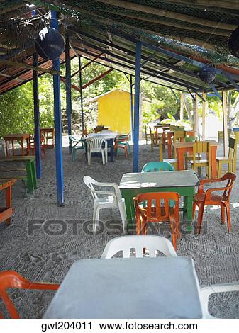 Empty tables and chairs in a restaurant, Providencia, Providencia y Santa Catalina, San Andres y Providencia Department, Colombia View Large Photo Image Stock Image - Empty tables and chairs in a restaurant, Providencia, Providencia y Santa Catalina, San Andres y Providencia Department, Colombia. Fotosearch