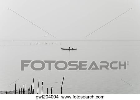Silhouette of a person boating in a river, Cienaga, Atlantico, Colombia View Large Photo Image Picture - Silhouette of a person boating in a river, Cienaga, Atlantico, Colombia. Fotosearch