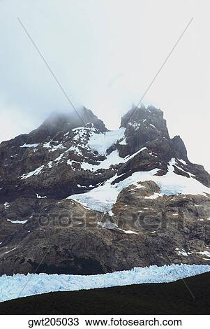 Fog over a mountain, Argentine Glaciers National Park, Lake Argentino, El Calafate, Patagonia, Argentina View Large Photo Image Stock Image - Fog over a mountain, Argentine Glaciers National Park, Lake Argentino, El Calafate, Patagonia, Argentina. Fotosearch