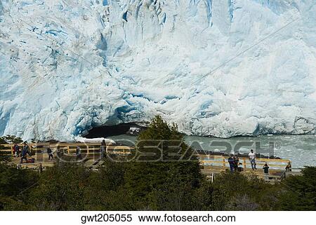 Stock Photography - High angle view of tourists in front of a glacier, Moreno Glacier, Argentine Glaciers National Park, Lake Argentino, El Calafate, Patagonia, Argentina. Fotosearch