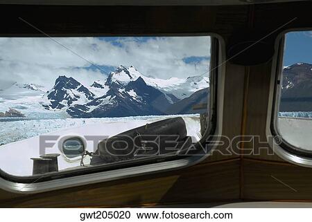 Stock Image - Mountain viewed through the window of a ship, Lake Argentino, Patagonia, Argentina. Fotosearch