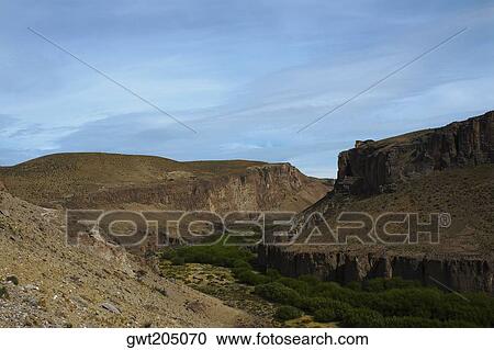 Trees surrounded by mountains, Pinturas River, Patagonia, Argentina View Large Photo Image Stock Image - Trees surrounded by mountains, Pinturas River, Patagonia, Argentina. Fotosearch