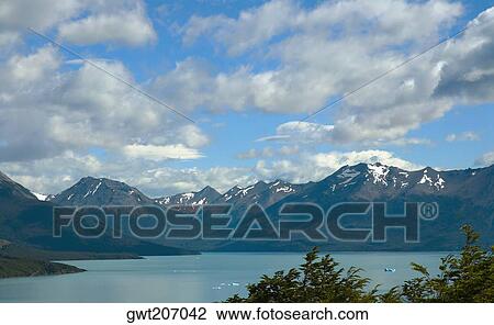 Stock Image - Lake in front of mountains, Lake Argentino, Patagonia, Argentina. Fotosearch