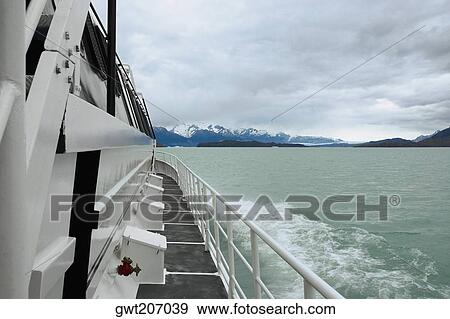 Yacht in a lake with mountains in the background, Lake Argentino, Patagonia, Argentina View Large Photo Image Stock Photo - Yacht in a lake with mountains in the background, Lake Argentino, Patagonia, Argentina. Fotosearch