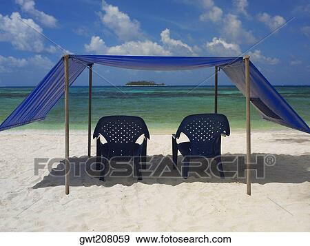 Empty chairs under the tent on the beach, Spratt Bight Beach, San Andres, Providencia y Santa Catalina, San Andres y Providencia Department, Colombia View Large Photo Image Stock Photo - Empty chairs under the tent on the beach, Spratt Bight Beach, San Andres, Providencia y Santa Catalina, San Andres y Providencia Department, Colombia. Fotosearch