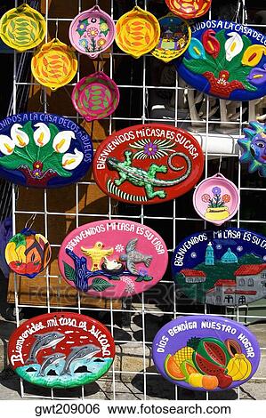 Ceramics hanging on a chain-linked fence, Cancun, Mexico View Large Photo Image Stock Photograph - Ceramics hanging on a chain-linked fence, Cancun, Mexico. Fotosearch