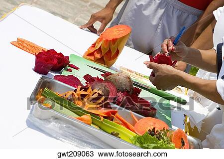 Close-up of a person's hands carving fruits and vegetables, Cancun, Mexico View Large Photo Image Stock Image - Close-up of a person's hands carving fruits and vegetables, Cancun, Mexico. Fotosearch