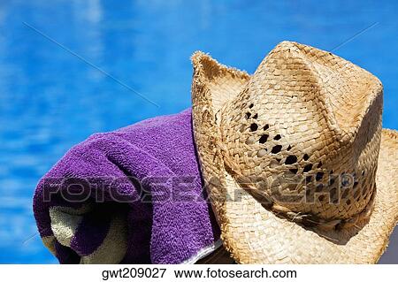 Close-up of a straw hat with a towel at the poolside, Cancun, Mexico View Large Photo Image Stock Photo - Close-up of a straw hat with a towel at the poolside, Cancun, Mexico. Fotosearch