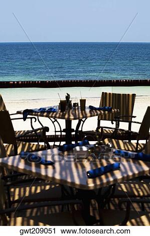 Empty chairs and tables on the beach, Cancun, Mexico View Large Photo Image Stock Image - Empty chairs and tables on the beach, Cancun, Mexico. Fotosearch