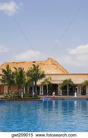 Swimming pool in front of a tourist resort, Cancun, Mexico View Large Photo Image Stock Photography - Swimming pool in front of a tourist resort, Cancun, Mexico. Fotosearch