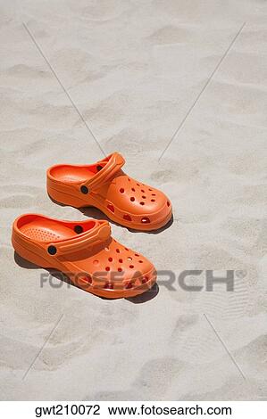 Close-up of a pair of sandals on the beach View Large Photo Image Stock Image - Close-up of a pair of sandals on the beach. Fotosearch