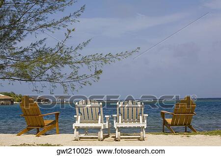 Four deck chairs on the beach, Dixon Cove, Roatan, Bay Islands, Honduras View Large Photo Image Stock Photography - Four deck chairs on the beach, Dixon Cove, Roatan, Bay Islands, Honduras. Fotosearch