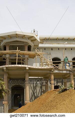 Low angle view of a building under construction, Roatan, Bay Islands, Honduras View Large Photo Image Stock Image - Low angle view of a building under construction, Roatan, Bay Islands, Honduras. Fotosearch