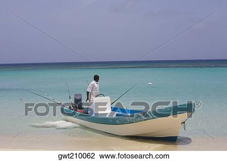 Man in a motorboat on the beach, Roatan, Bay Islands, Honduras View Large Photo Image Stock Image - Man in a motorboat on the beach, Roatan, Bay Islands, Honduras. Fotosearch