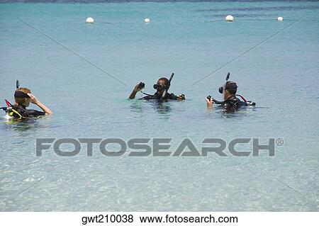 Three people snorkeling in the sea, Roatan, Bay Islands, Honduras View Large Photo Image Stock Photo - Three people snorkeling in the sea, Roatan, Bay Islands, Honduras. Fotosearch