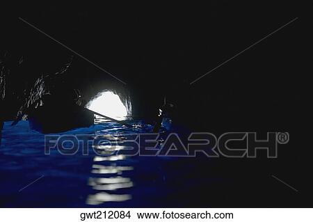 Picture - Boat under a rock formation, Faraglioni Rocks, Capri, Campania, Italy. Fotosearch