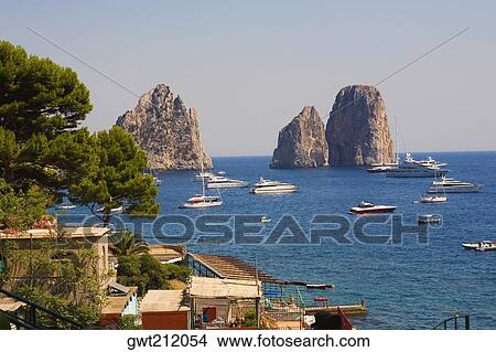 Boats in the sea, Faraglioni Rocks, Capri, Campania, Italy View Large Photo Image Picture - Boats in the sea, Faraglioni Rocks, Capri, Campania, Italy. Fotosearch