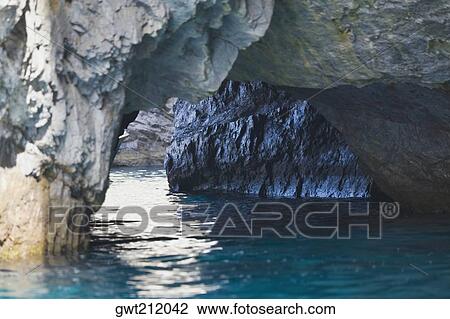Close-up of a natural arch in a rock formation, Faraglioni Rocks, Capri, Campania, Italy View Large Photo Image Stock Image - Close-up of a natural arch in a rock formation, Faraglioni Rocks, Capri, Campania, Italy. Fotosearch
