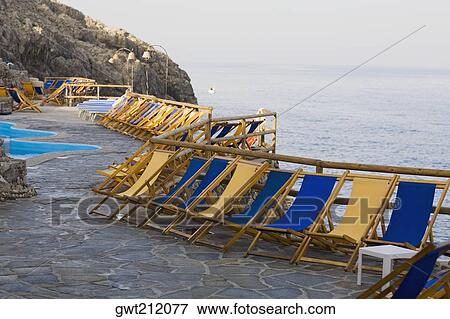 Deck chairs in a row, Capri, Campania, Italy View Large Photo Image Stock Photo - Deck chairs in a row, Capri, Campania, Italy. Fotosearch