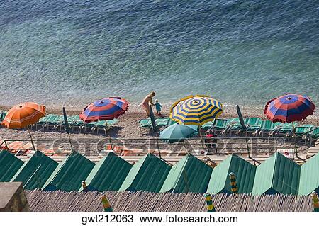 High angle view of beach umbrella with beach chairs, Marine Piccola Beach, Capri, Campania, Italy View Large Photo Image Stock Image - High angle view of beach umbrella with beach chairs, Marine Piccola Beach, Capri, Campania, Italy. Fotosearch