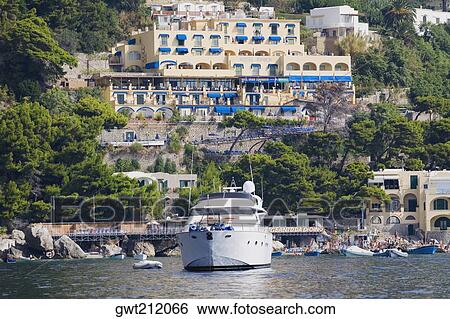 Passenger ship in the sea with buildings in the background, Capri, Campania, Italy View Large Photo Image Stock Photograph - Passenger ship in the sea with buildings in the background, Capri, Campania, Italy. Fotosearch