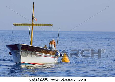 Rear view of a man in a boat, Capri, Campania, Italy View Large Photo Image Stock Image - Rear view of a man in a boat, Capri, Campania, Italy. Fotosearch