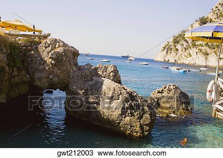 Rock formations in the sea, Capri, Campania, Italy View Large Photo Image Stock Image - Rock formations in the sea, Capri, Campania, Italy. Fotosearch