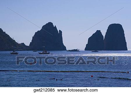 Silhouette of rock formations at dusk, Faraglioni Rocks, Capri, Campania, Italy View Large Photo Image Stock Photography - Silhouette of rock formations at dusk, Faraglioni Rocks, Capri, Campania, Italy. Fotosearch