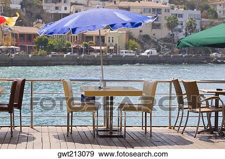 Chairs and tables in a restaurant at the seaside, Ephesus, Turkey View Large Photo Image Stock Photo - Chairs and tables in a restaurant at the seaside, Ephesus, Turkey. Fotosearch