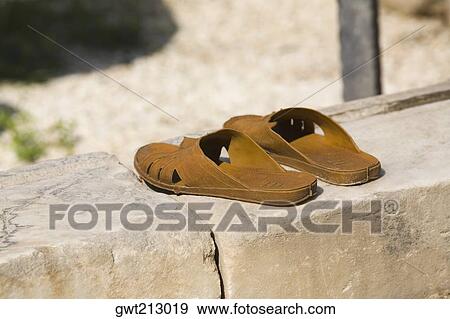 Pair of sandals on a stone wall, Ephesus, Turkey View Large Photo Image Stock Photo - Pair of sandals on a stone wall, Ephesus, Turkey. Fotosearch