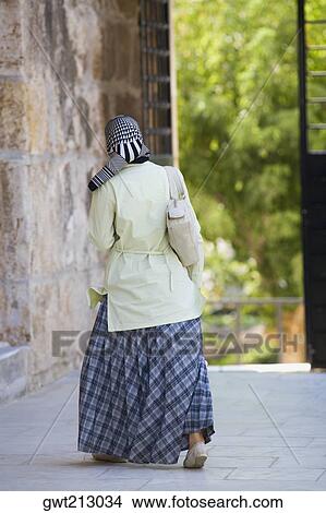Rear view of a woman walking, Ephesus, Turkey View Large Photo Image Picture - Rear view of a woman walking, Ephesus, Turkey. Fotosearch