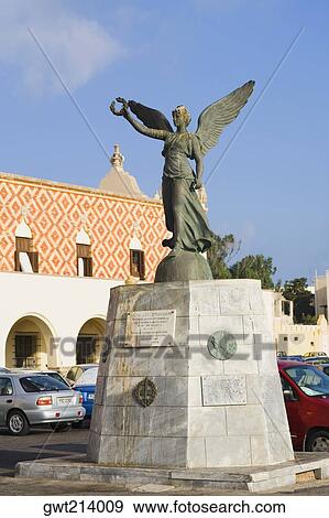 Stock Photo - Angel statue in front of a building, Rhodes, Dodecanese Islands, Greece. Fotosearch