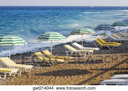 Beach umbrellas and lounge chairs on the beach, Rhodes, Dodecanese Islands, Greece View Large Photo Image Picture - Beach umbrellas and lounge chairs on the beach, Rhodes, Dodecanese Islands, Greece. Fotosearch