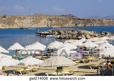 Stock Photo - Beach umbrellas on the beach, Lindos, Rhodes, Dodecanese Islands, Greece. Fotosearch