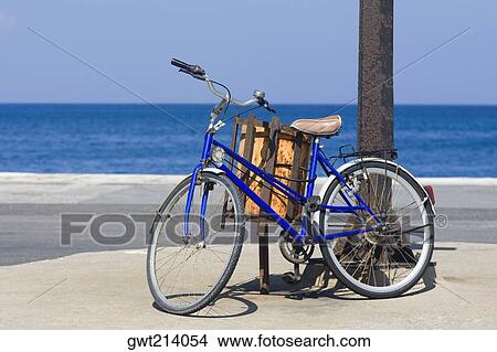 Bicycle by a pole on the beach, Rhodes, Dodecanese Islands, Greece View Large Photo Image Picture - Bicycle by a pole on the beach, Rhodes, Dodecanese Islands, Greece. Fotosearch