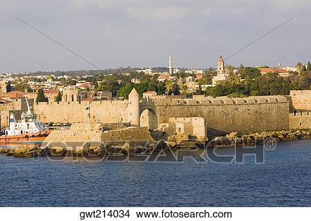 Picture - Fortress along the sea, Mandraki Harbor, Rhodes, Dodecanese Islands, Greece. Fotosearch
