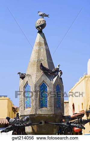 Fountain in the courtyard of a town, Sintrivani Fountain, Hippocrates Square, Rhodes, Dodecanese Islands, Greece View Large Photo Image Stock Photograph - Fountain in the courtyard of a town, Sintrivani Fountain, Hippocrates Square, Rhodes, Dodecanese Islands, Greece. Fotosearch
