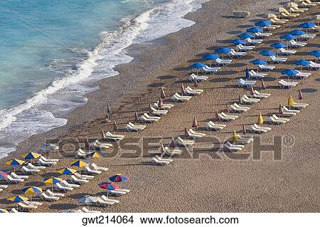 High angle view of beach umbrellas and lounge chairs on the beach, Rhodes, Dodecanese Islands, Greece View Large Photo Image Picture - High angle view of beach umbrellas and lounge chairs on the beach, Rhodes, Dodecanese Islands, Greece. Fotosearch